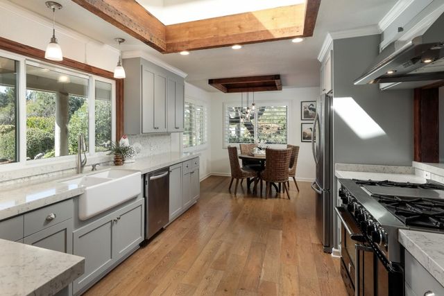 a kitchen with a table chairs a sink and appliances