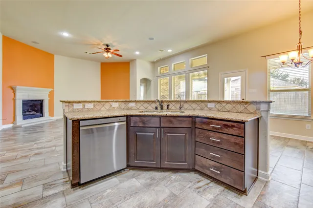 a spacious bathroom with a granite countertop sink and a mirror