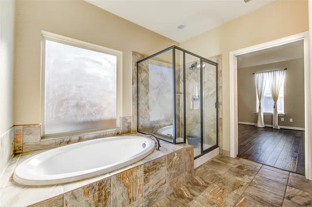 a bathroom with a tub and a shower