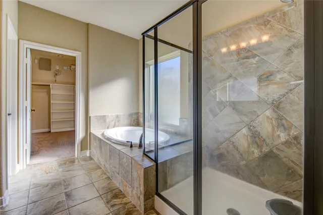 a bathroom with a tub shower and sink