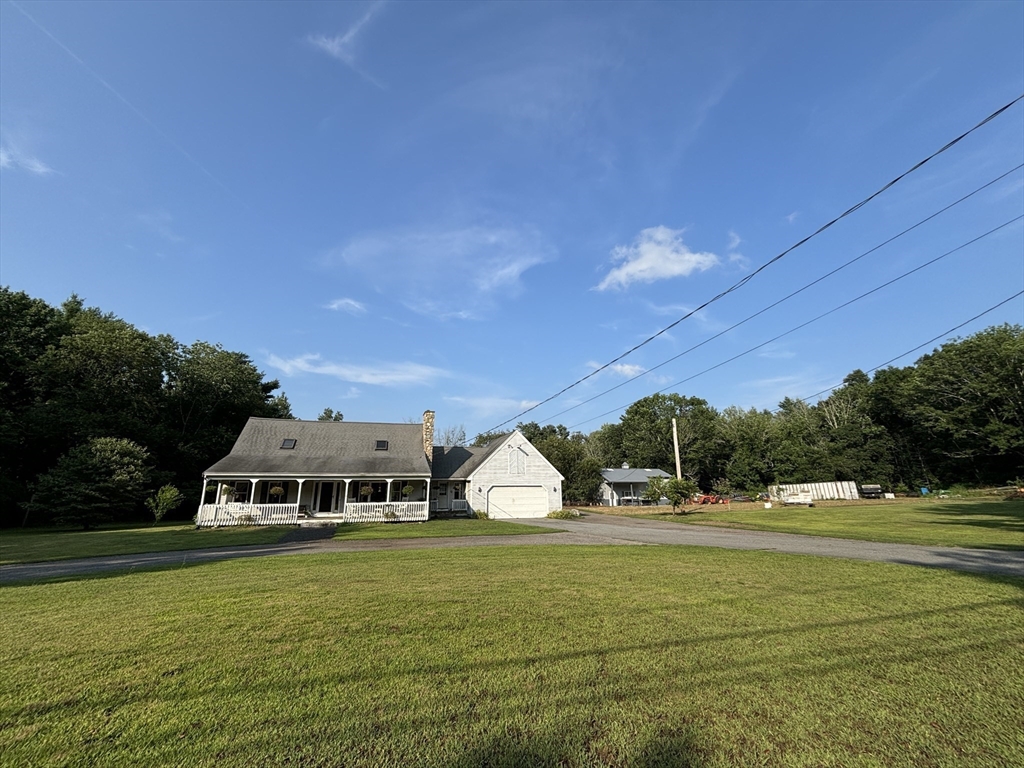 924 Walnut Plain Road Rochester, MA 02770 - Photo 1 of 36 a front view of a house with a yard and trees