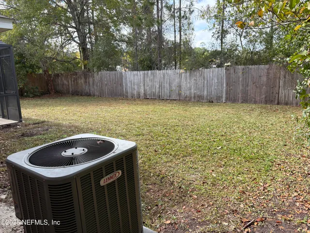 a kitchen with a sink a refrigerator and a yard