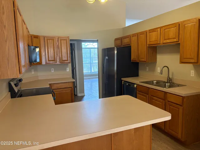 a kitchen with stainless steel appliances a refrigerator and a stove