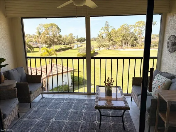 a balcony with table and chairs