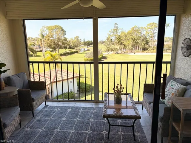 a balcony with table and chairs