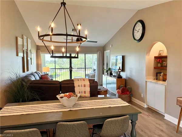 a living room with furniture a table and a chandelier