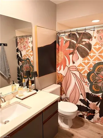 a bathroom with a sink toilet and shower