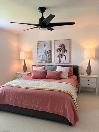 a bedroom with a bed and a painting on the wall