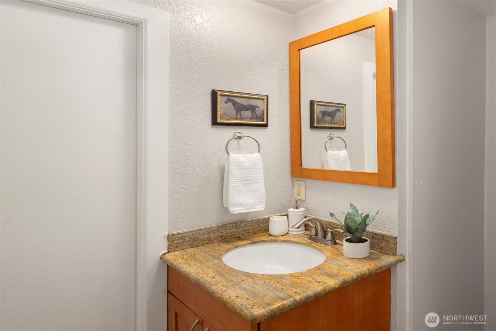 10330 Southeast 6th Street, Unit A2 Bellevue, WA 98004 - Photo 21 of 27 a bathroom with a granite countertop sink and a mirror