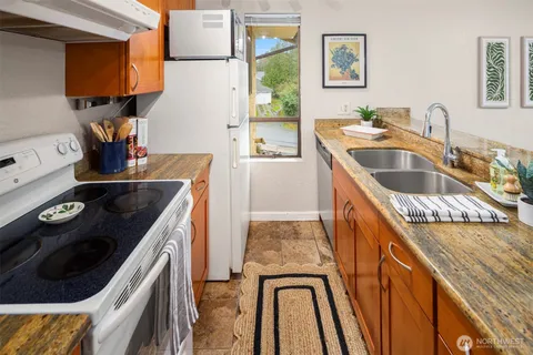 a kitchen with a sink stove and refrigerator