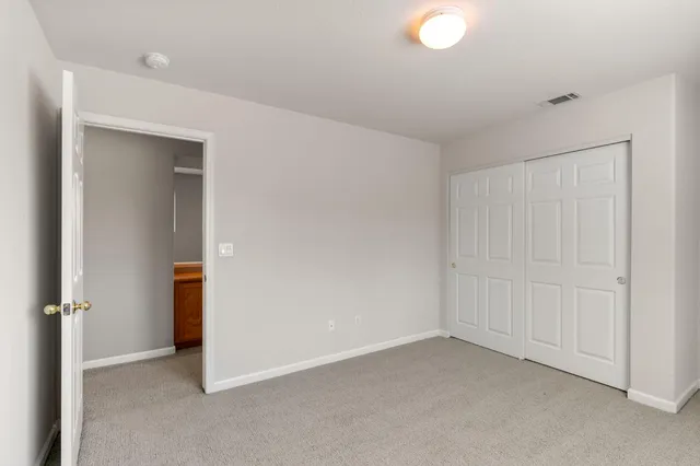 an empty room with closet area