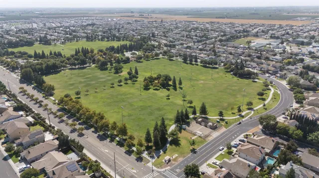 an aerial view of a residential houses with outdoor space