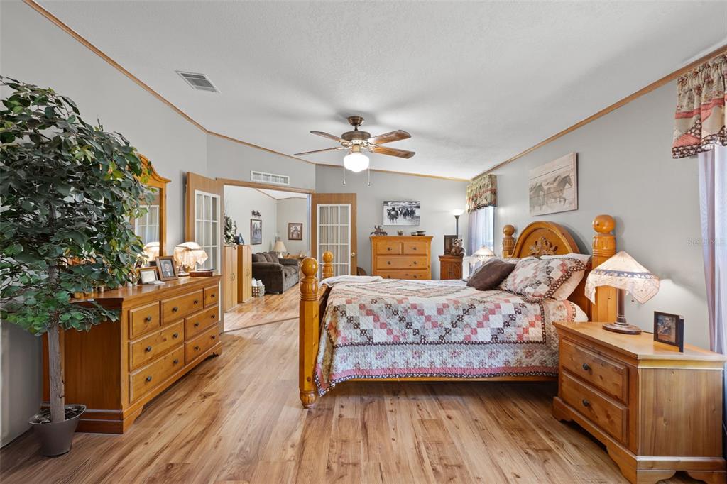 6689 Southeast 55th Street Trenton, FL 32693 - Photo 22 of 83 a bedroom with a bed and wooden floor