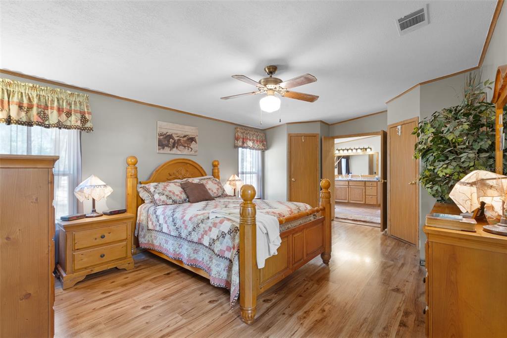 6689 Southeast 55th Street Trenton, FL 32693 - Photo 23 of 83 a bedroom with a bed and wooden floor