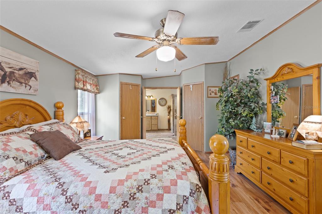 6689 Southeast 55th Street Trenton, FL 32693 - Photo 24 of 83 a bedroom with a bed and a chandelier