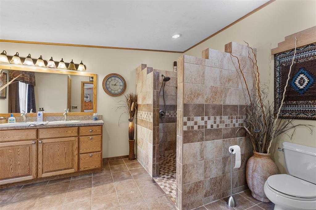 6689 Southeast 55th Street Trenton, FL 32693 - Photo 25 of 83 a spacious bathroom with a toilet a sink and shower