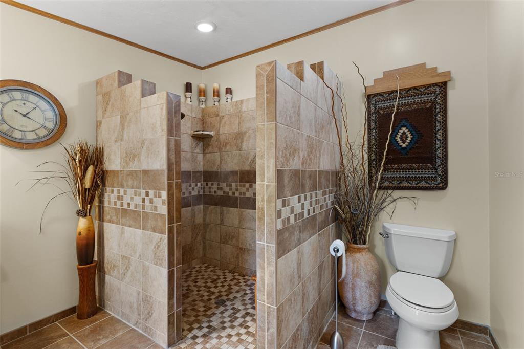 6689 Southeast 55th Street Trenton, FL 32693 - Photo 29 of 83 a bathroom with a toilet and a shower