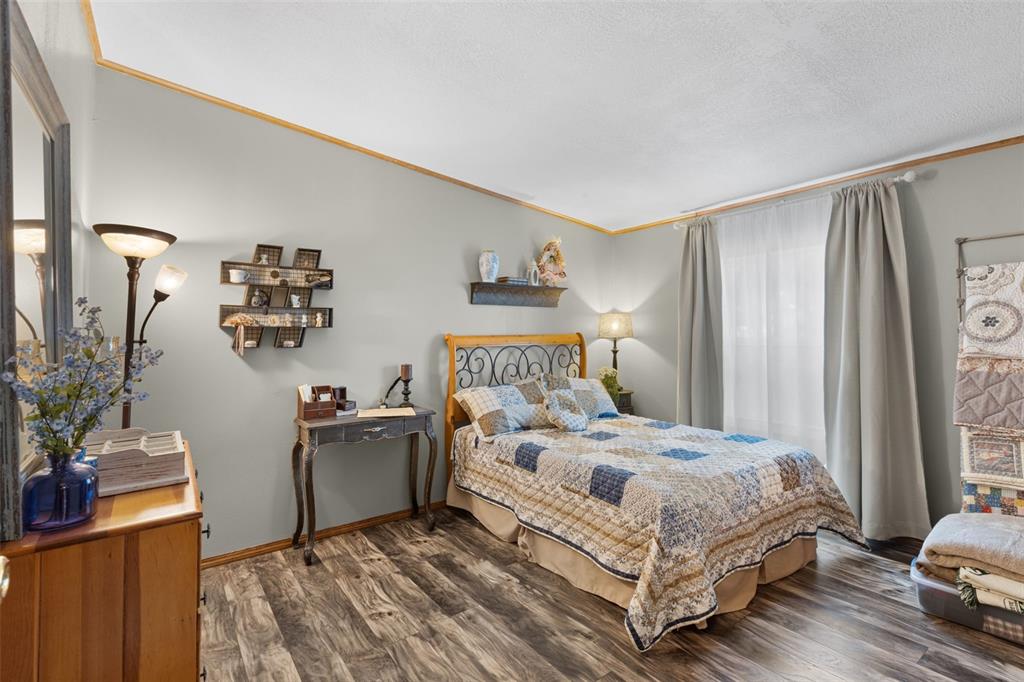 6689 Southeast 55th Street Trenton, FL 32693 - Photo 40 of 83 a bedroom with a bed and a dresser in it