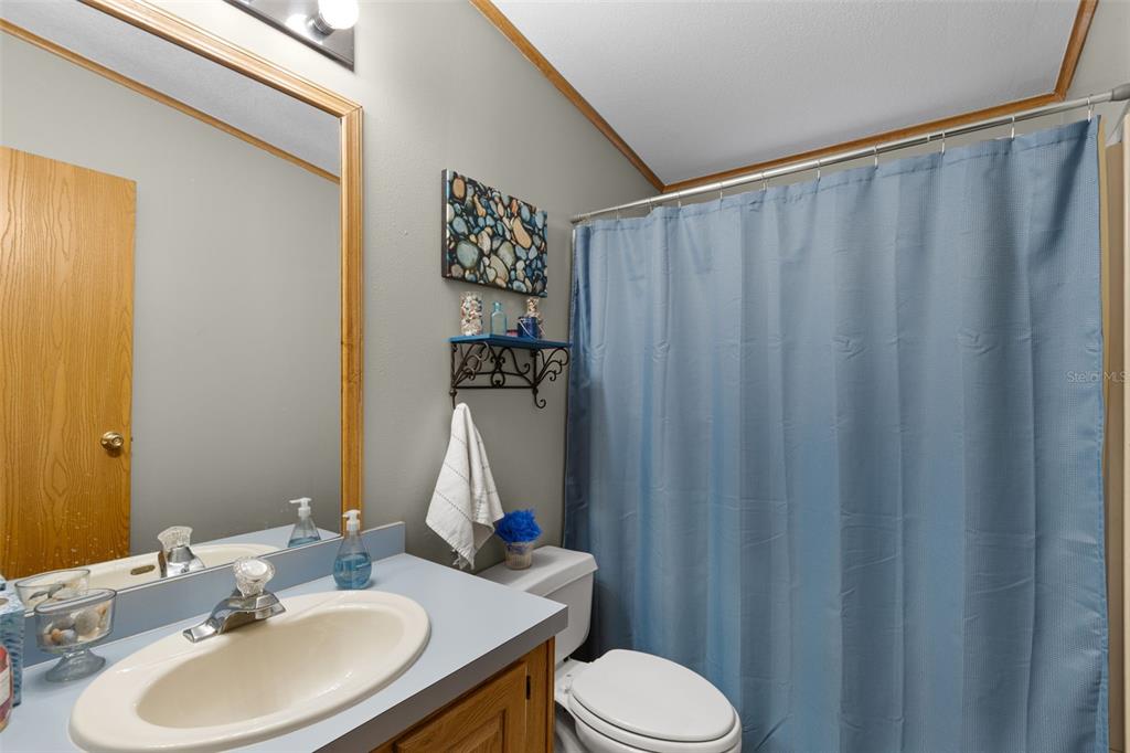 6689 Southeast 55th Street Trenton, FL 32693 - Photo 42 of 83 a bathroom with a sink and a mirror