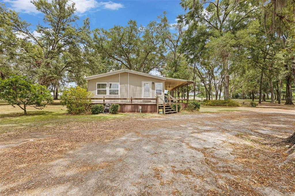 6689 Southeast 55th Street Trenton, FL 32693 - Photo 46 of 83 a view of a house with a yard