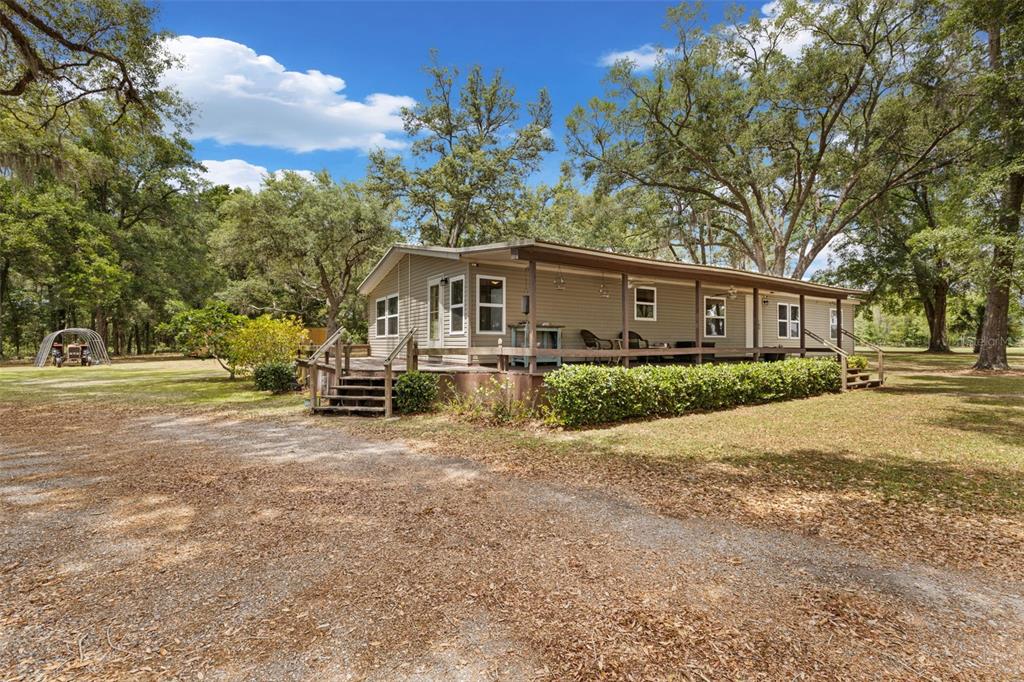 6689 Southeast 55th Street Trenton, FL 32693 - Photo 47 of 83 a front view of a house with a yard and trees