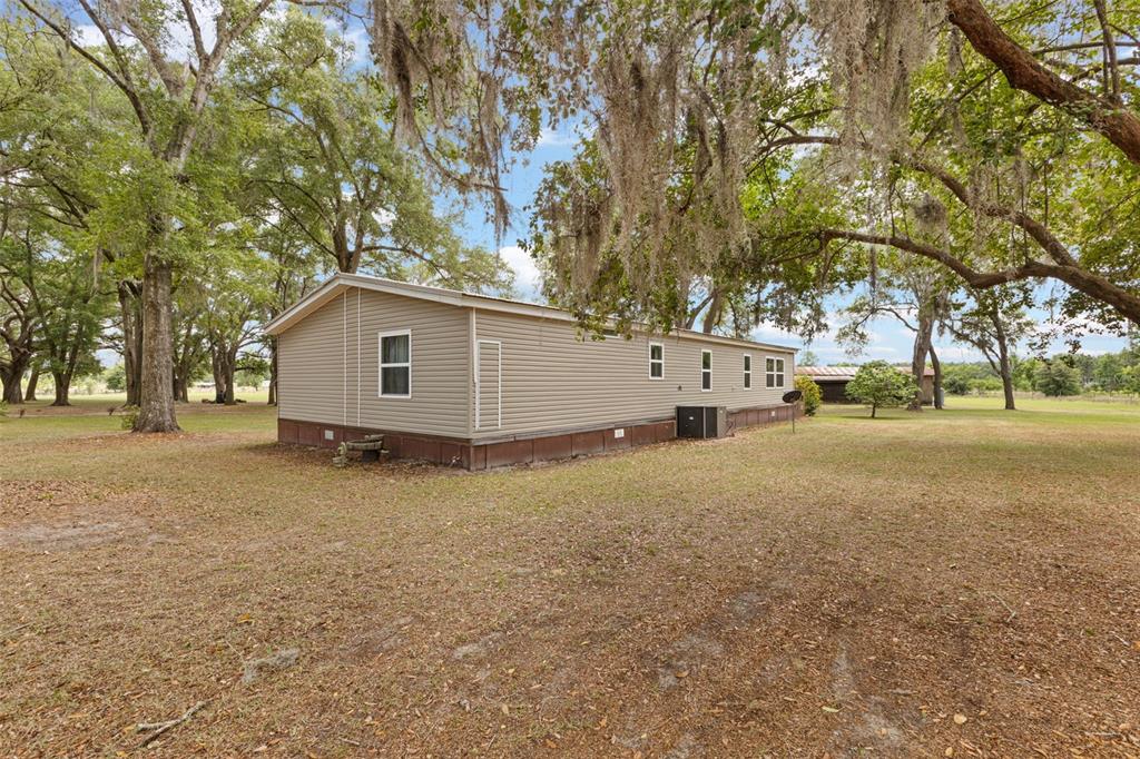 6689 Southeast 55th Street Trenton, FL 32693 - Photo 48 of 83 a view of a house with a yard and garage