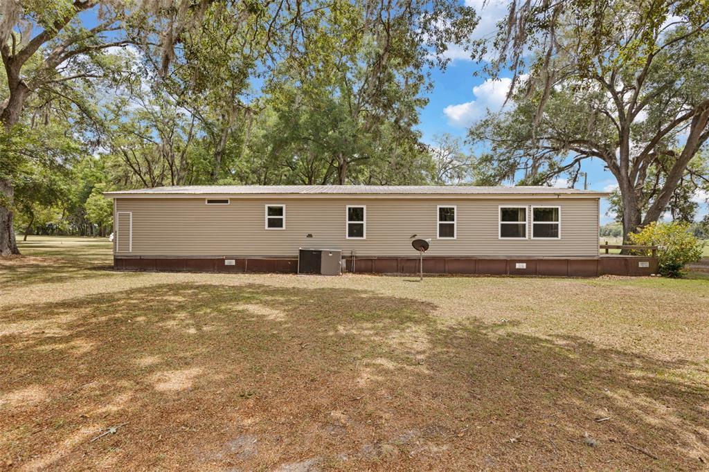 6689 Southeast 55th Street Trenton, FL 32693 - Photo 49 of 83 a front view of a house with yard and trees
