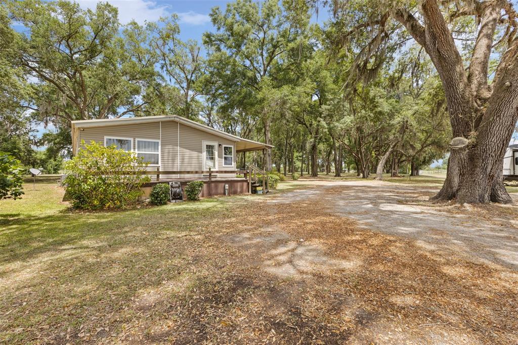 6689 Southeast 55th Street Trenton, FL 32693 - Photo 55 of 83 a house with trees in front of it
