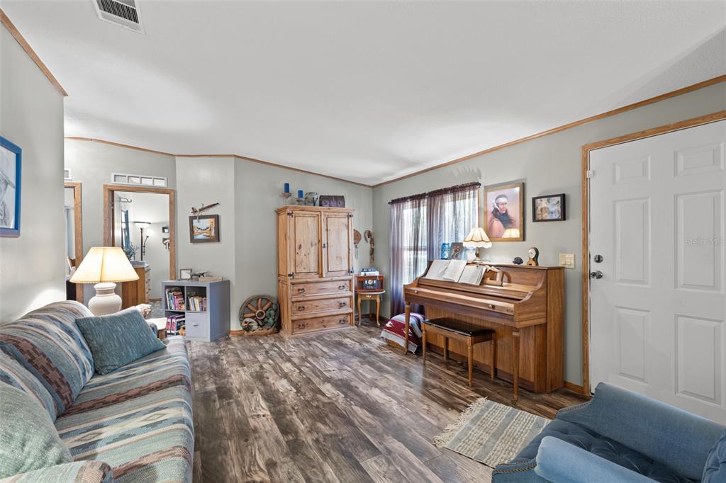 6689 Southeast 55th Street Trenton, FL 32693 - Photo 6 of 83 a living room with furniture and a wooden floor