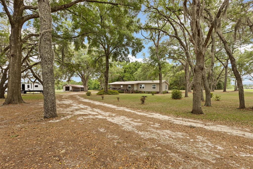 6689 Southeast 55th Street Trenton, FL 32693 - Photo 69 of 83 a house with trees in front of it
