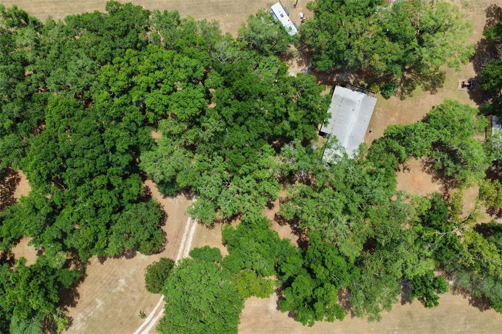 6689 Southeast 55th Street Trenton, FL 32693 - Photo 74 of 83 an aerial view of a house with a yard and lake view