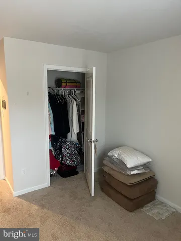 a living room with a hallway and closet