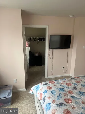 a bedroom with a bed and a view of bathroom