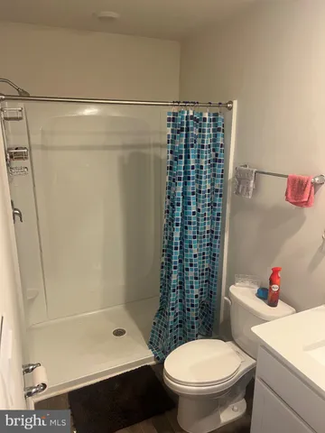 a bathroom with a toilet and a shower