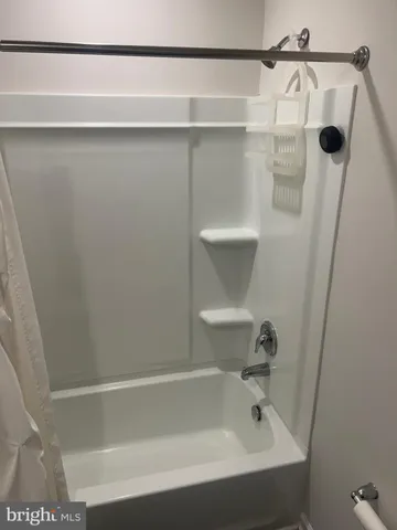 a bathroom with a shower and a bath tub
