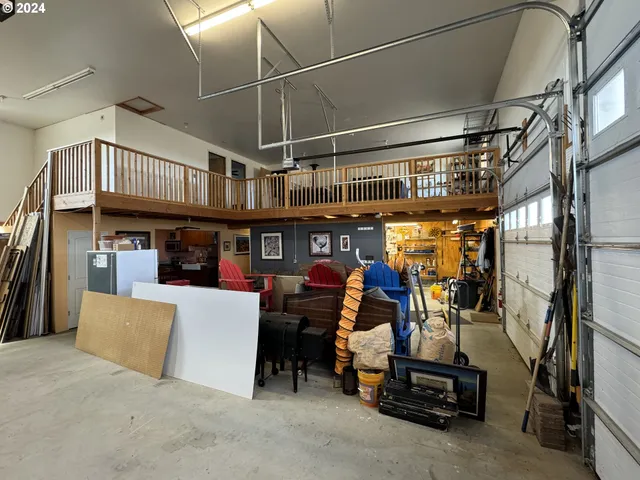 a kitchen with sink refrigerator dining table and chairs