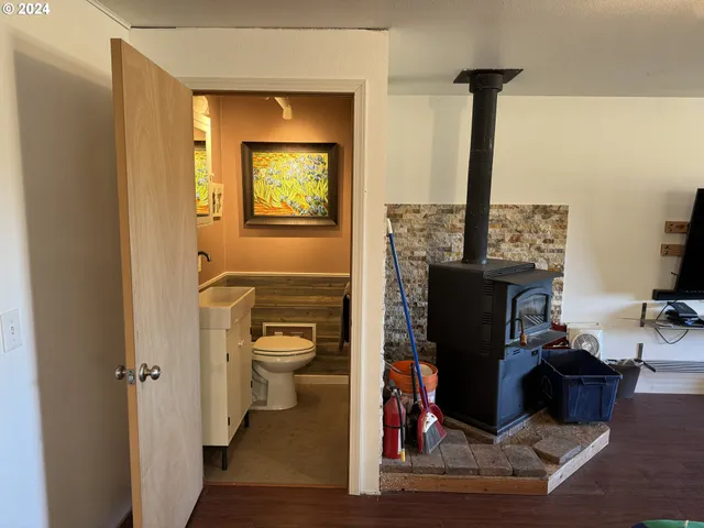 a living room with lots of wooden furniture and a large window