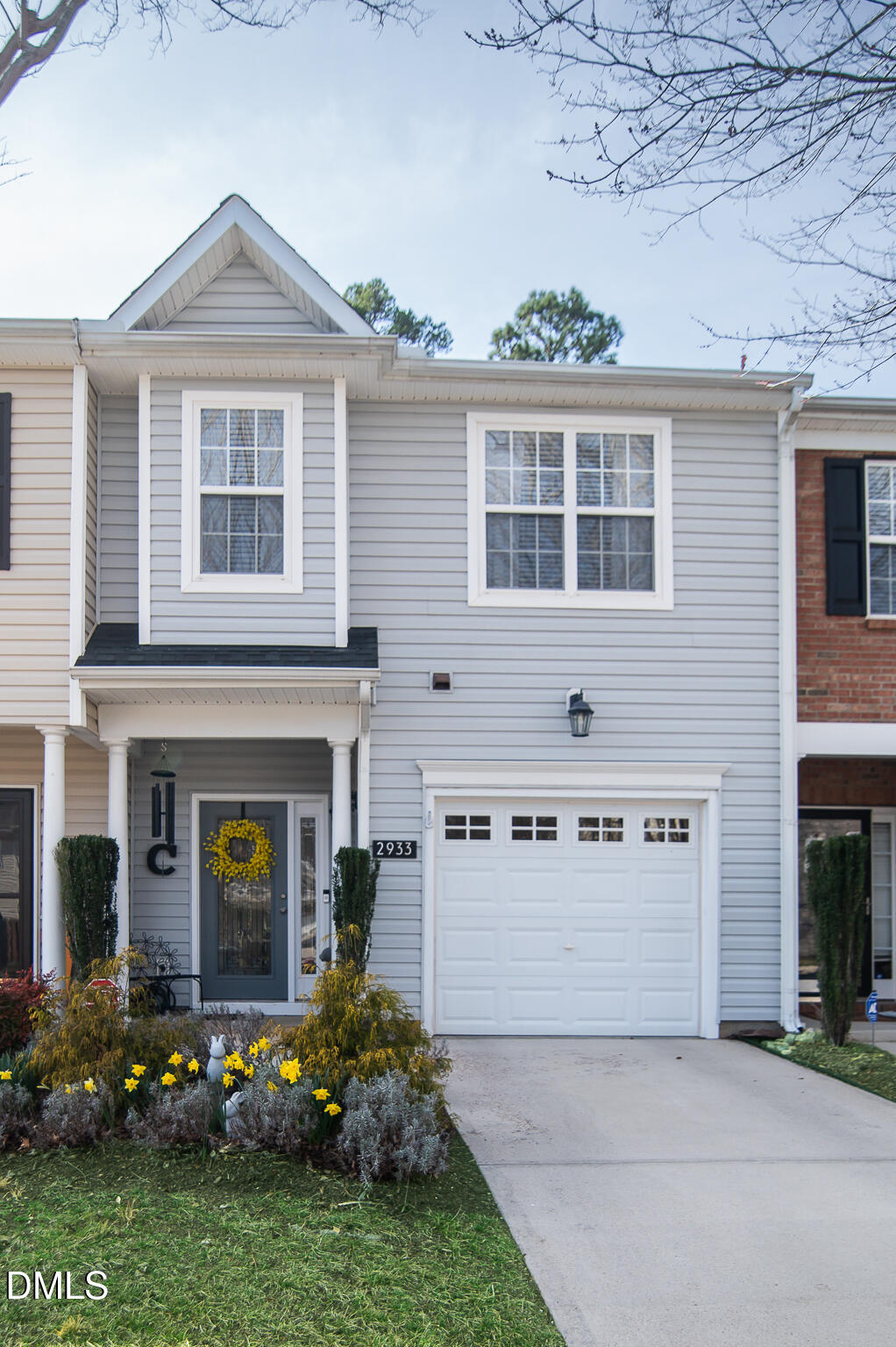 2933 Winding Waters Way Raleigh, NC 27614 - Photo 2 of 24 a front view of a house with a garden and plants