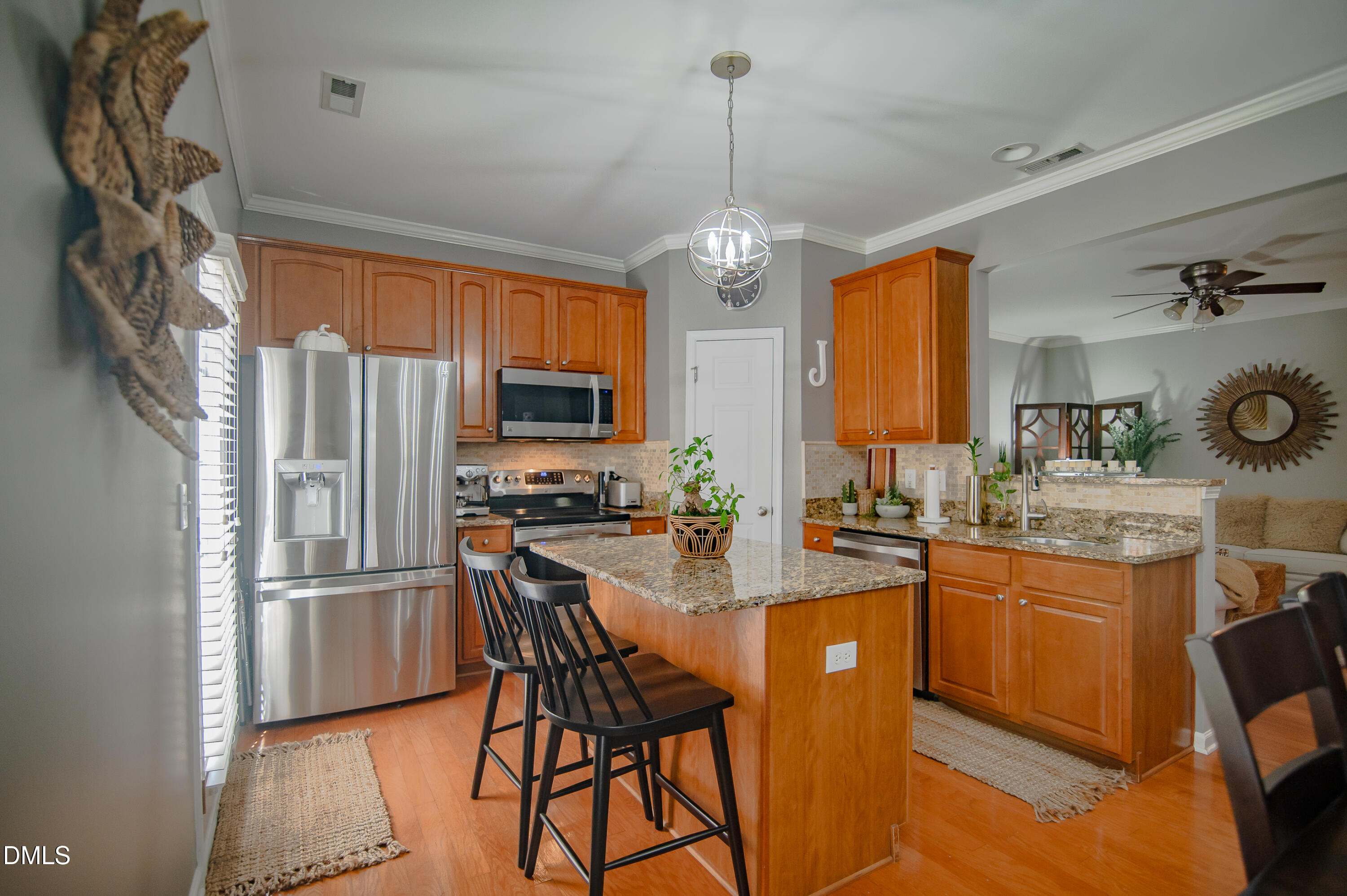 2933 Winding Waters Way Raleigh, NC 27614 - Photo 10 of 24 a kitchen with stainless steel appliances granite countertop a refrigerator a sink dishwasher a stove and a dining table with wooden floor