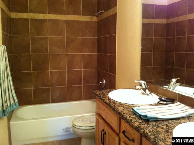 1455 Locksley Way Reno, NV 89503 - Photo 4 of 5 a bathroom with a granite countertop bathtub sink and toilet