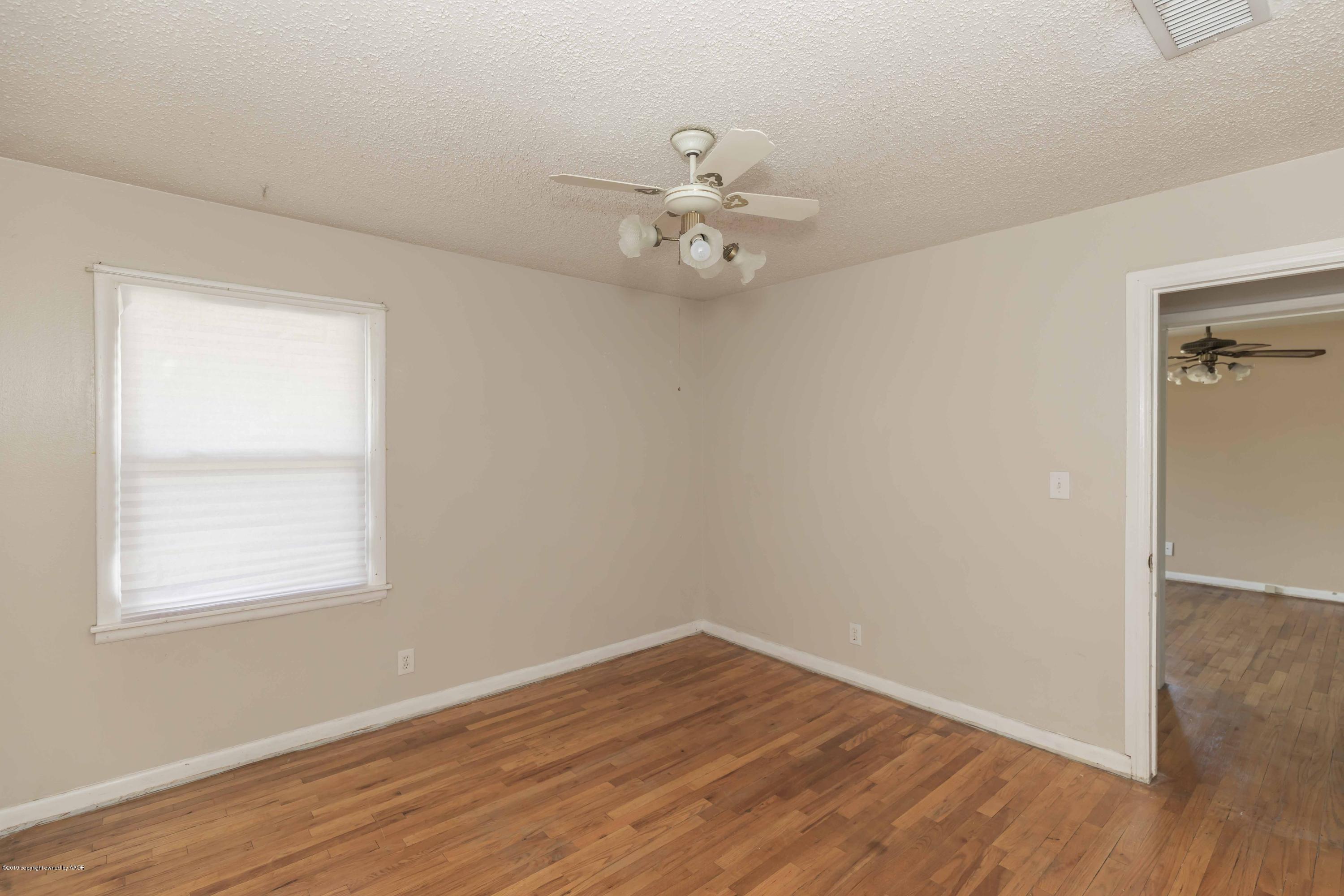 3524 Lometa Drive Amarillo, TX 79109 - Photo 18 of 21 an empty room with wooden floor ceiling fan and window