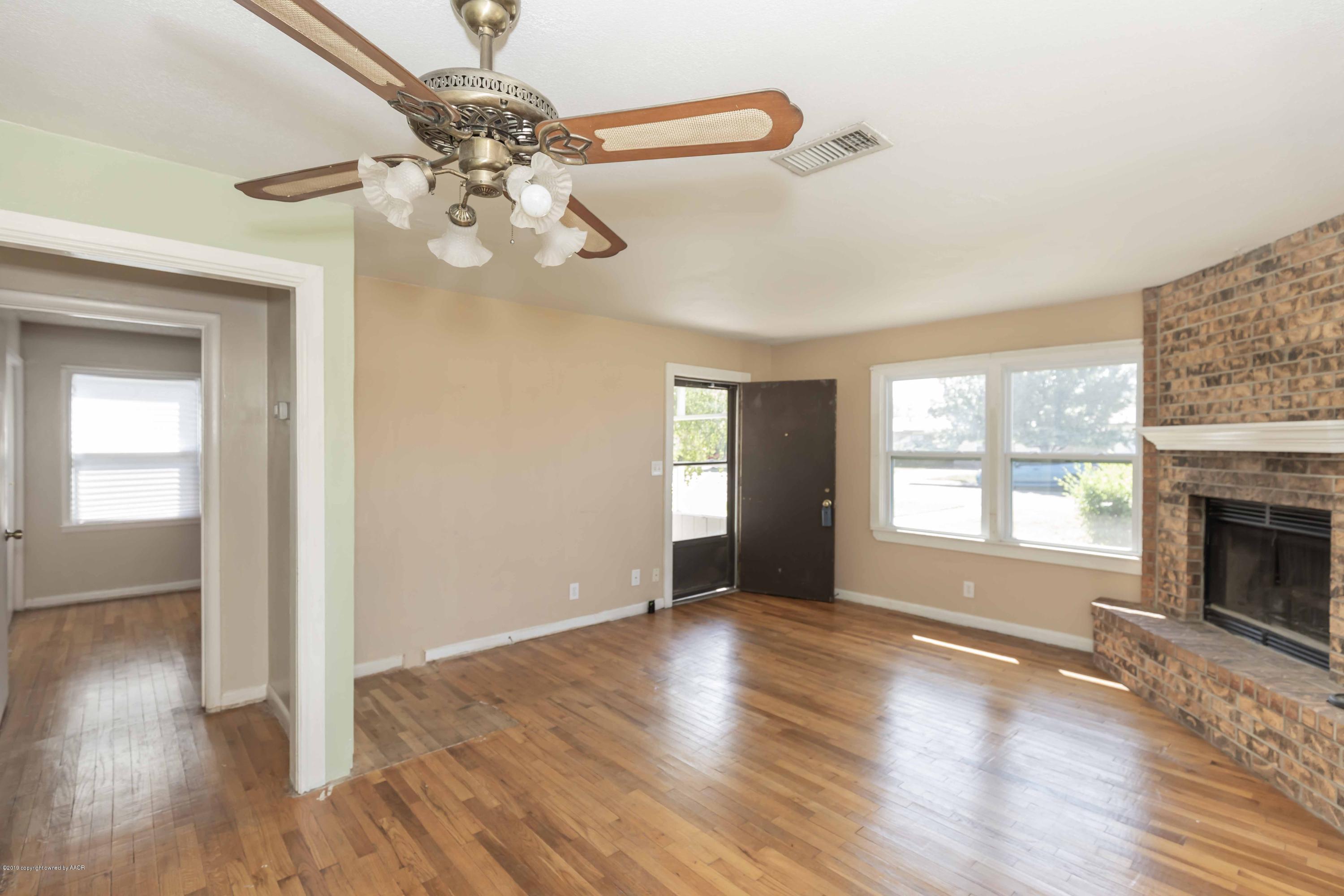 3524 Lometa Drive Amarillo, TX 79109 - Photo 6 of 21 a view of livingroom with window fireplace and wooden floor