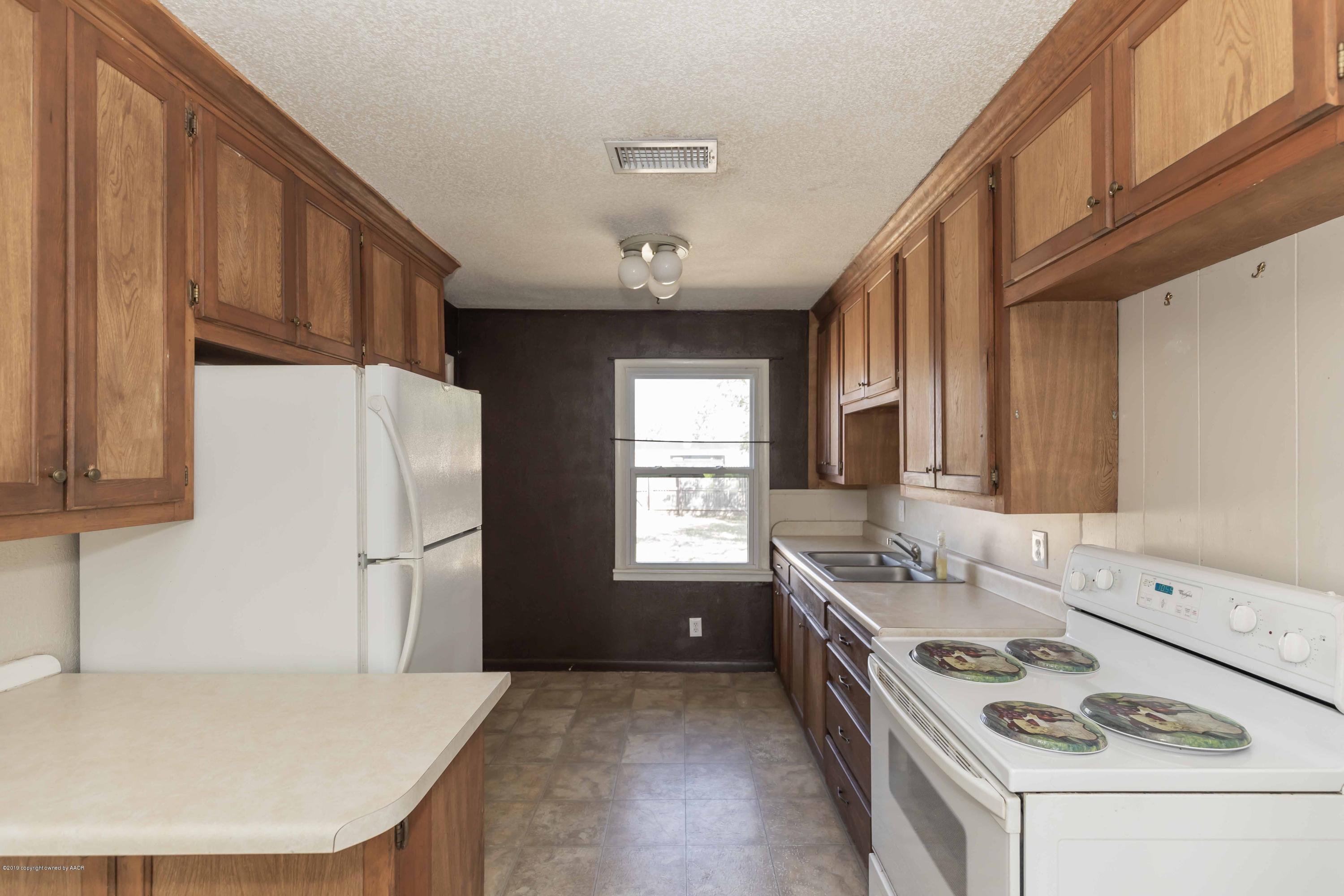 3524 Lometa Drive Amarillo, TX 79109 - Photo 7 of 21 a kitchen with a stove a refrigerator and a sink