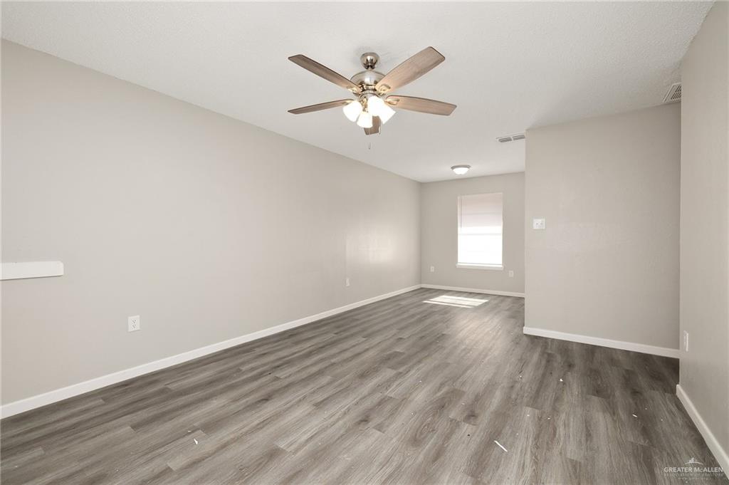 2800 North 30th Street McAllen, TX 78501 - Photo 6 of 12 an empty room with wooden floor fan and windows