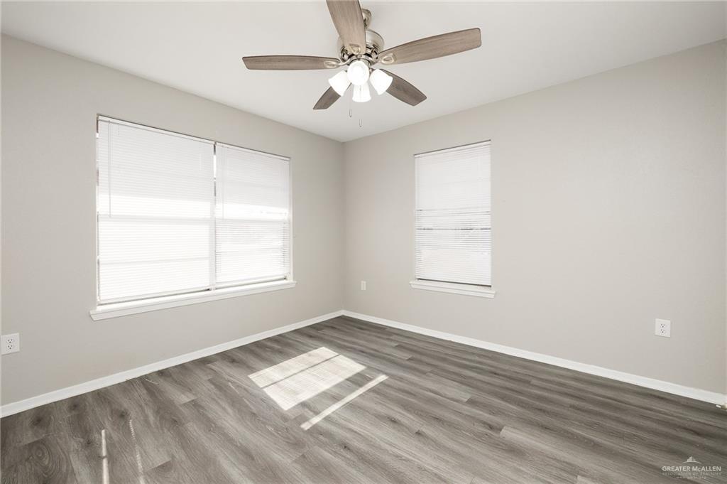 2800 North 30th Street McAllen, TX 78501 - Photo 9 of 12 an empty room with windows and ceiling fan