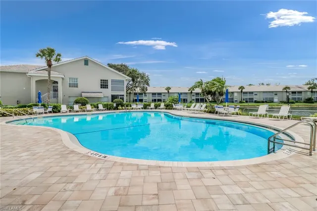 a swimming pool with outdoor seating and plants