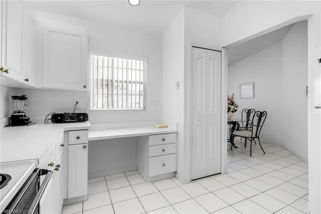 a kitchen with a cabinets and chairs