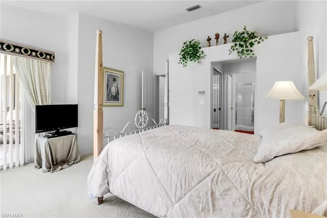 a bedroom with a bed and a flat screen television