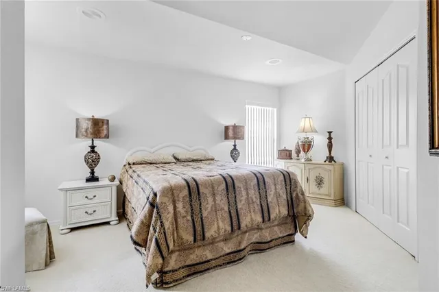 a spacious bedroom with a bed and a cabinets