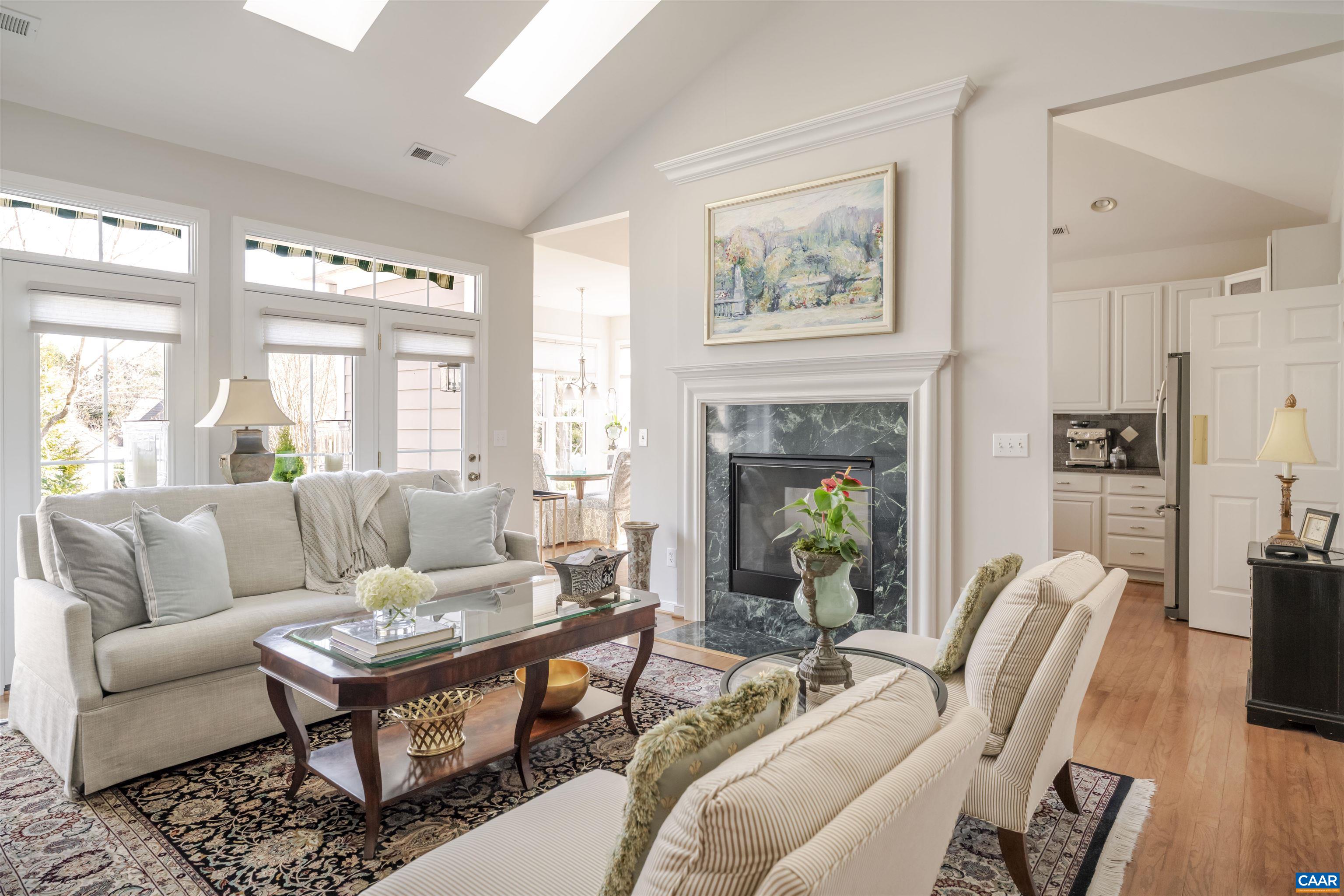 1322 Stonegate Court Crozet, VA 22932 - Photo 11 of 39 a living room with furniture a table and a fireplace